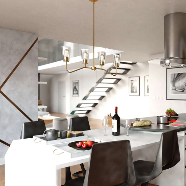 Beverly 36-inch 4 Light Linear Chandelier in satin brass finish installed above a modern dining table, featuring clear tapered glass shades and curved steel arms