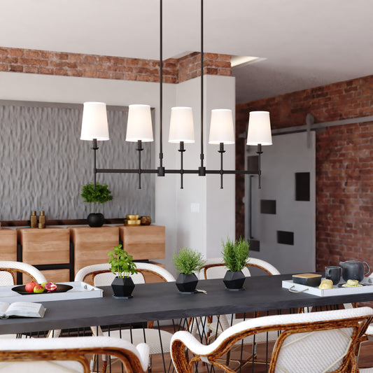 Camden 45.5-inch 5 Light Linear Chandelier in matte black displayed in a modern dining room with brick walls, wood textures, and contemporary decor elements