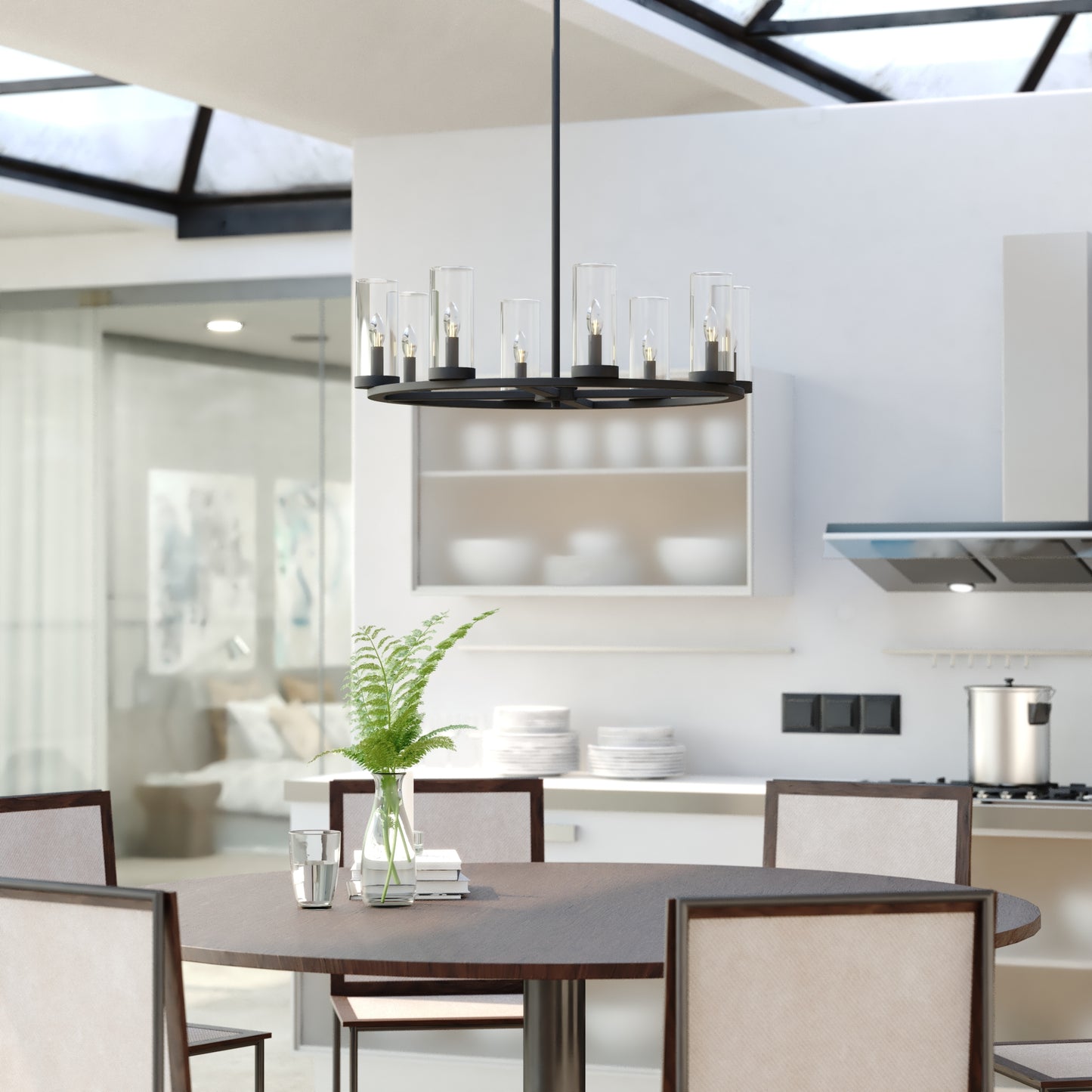 Grantley 30-inch 8-light black chandelier with clear glass cylinders hanging over a dining table in a modern kitchen.