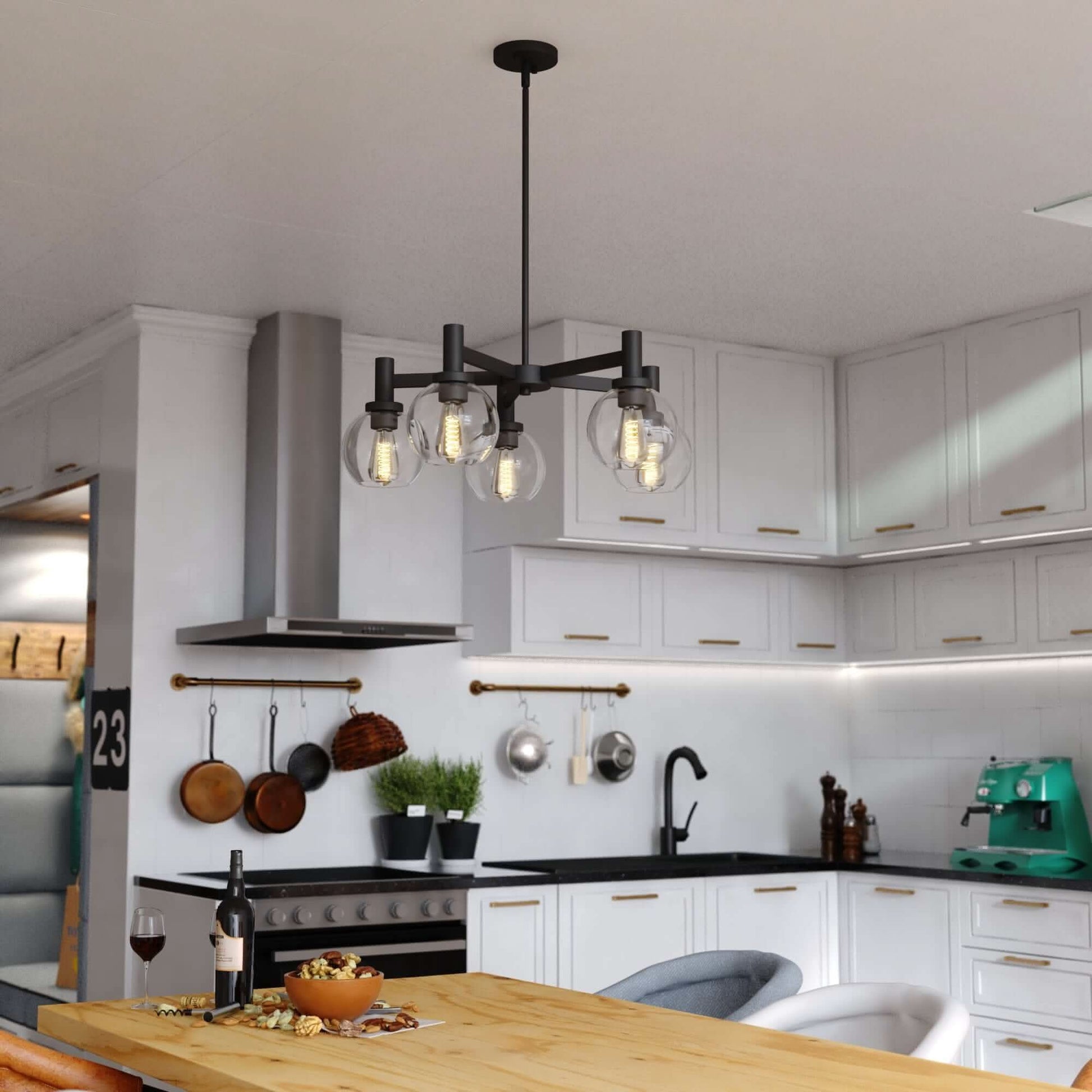 Marshall 27-inch 5 Light chandelier displayed in a modern kitchen, featuring matte black arms with clear glass globes and Edison-style bulbs.