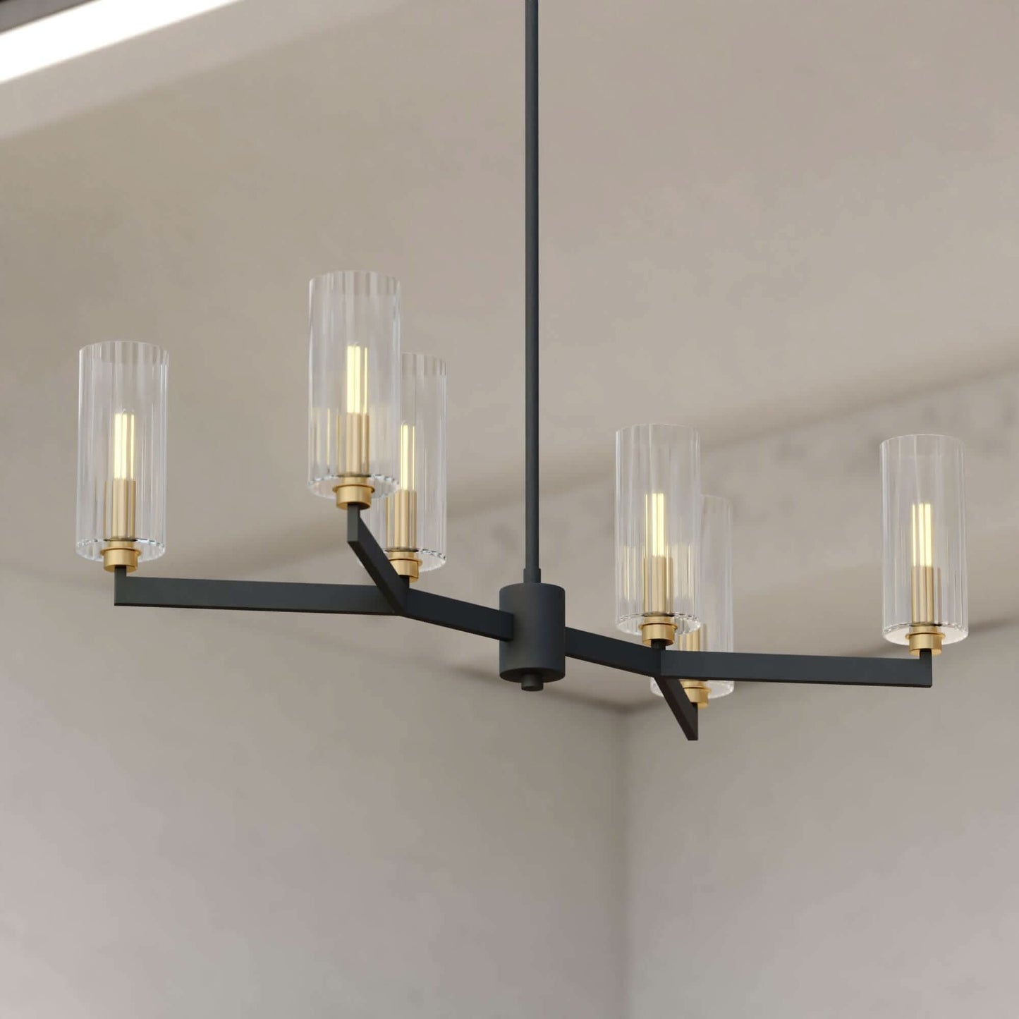 Claremont 31.25-inch 6 Light chandelier featuring a branching black frame with clear ribbed glass shades and brass accents against a room corner.