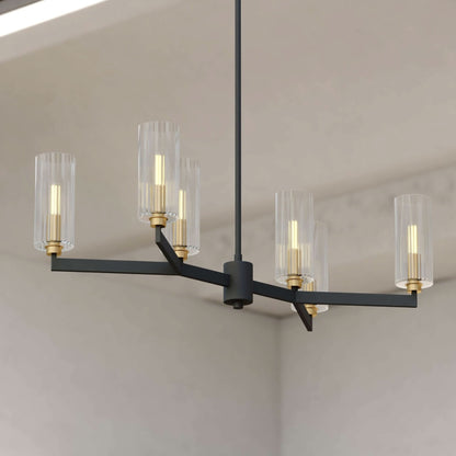 Claremont 31.25-inch 6 Light chandelier featuring a branching black frame with clear ribbed glass shades and brass accents against a room corner.