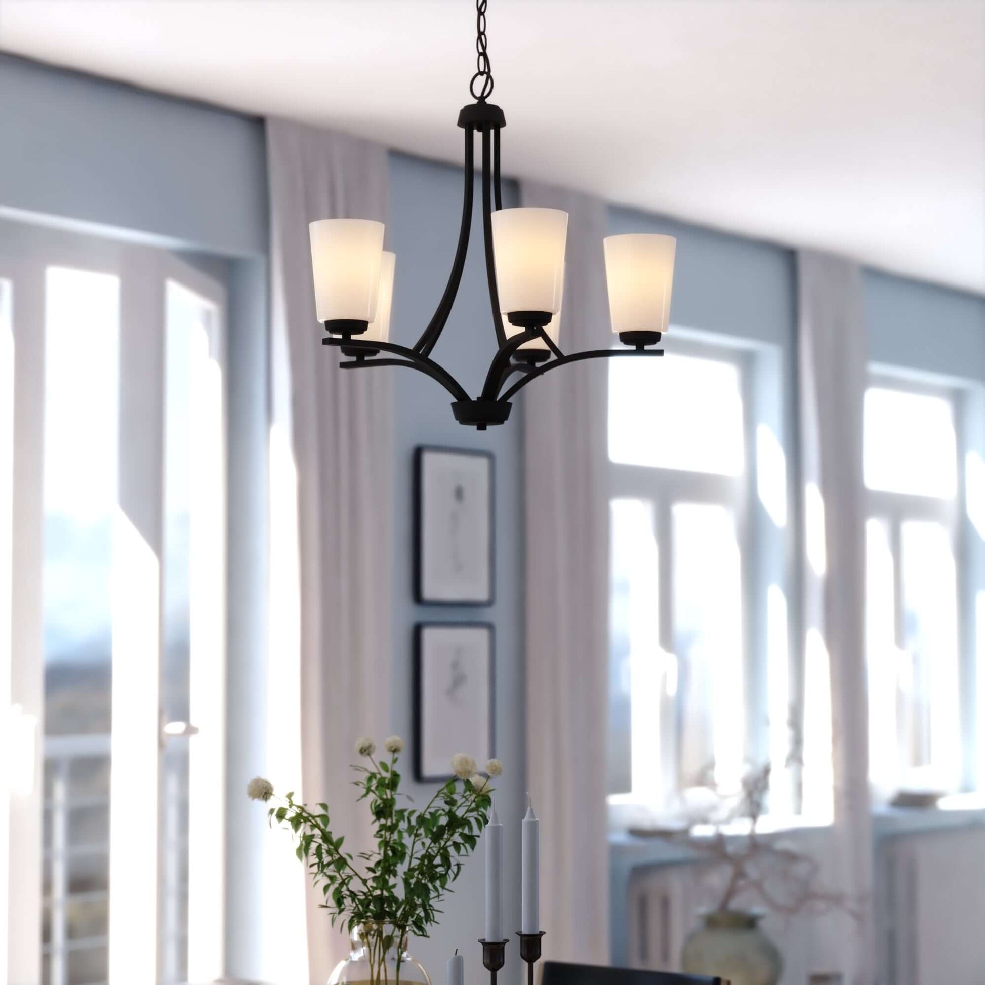 River Grove 24.75-inch wide 5-light chandelier in matte black, shown in a lifestyle installation with frosted glass shades and chain suspension.